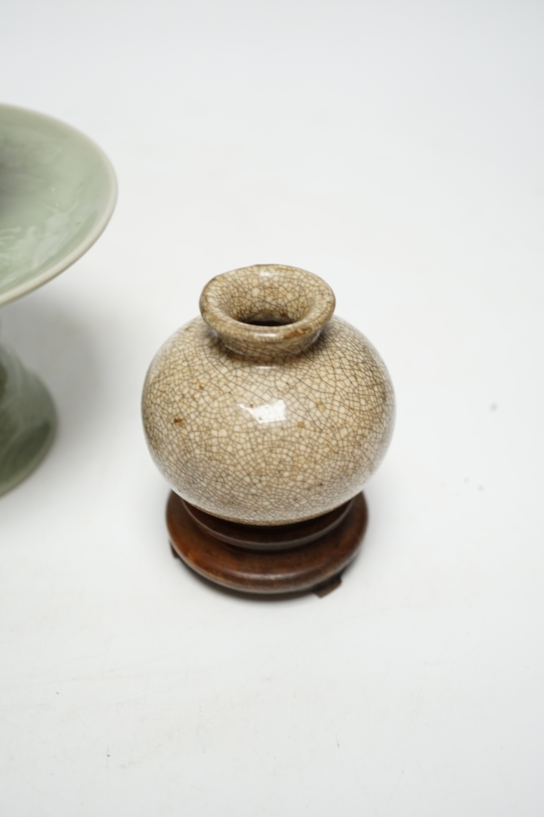 A Chinese celadon glazed 'dragon' puzzle cup and stand, early 20th century and a Chinese crackle glaze vase, 19th century, cup 7.5cm